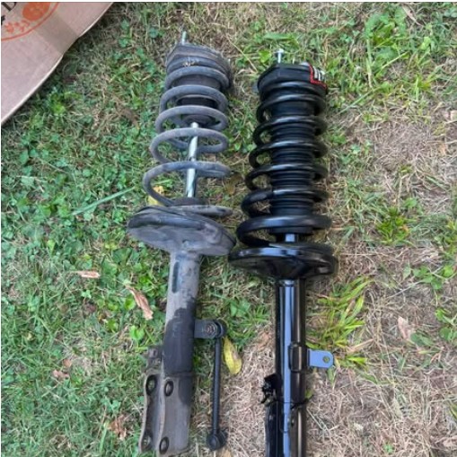 Worn strut next to a new replacement strut